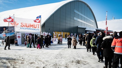 People wait in line to vote in the Inussivik arena in Nuuk, Greenland, April 6, 2021.
