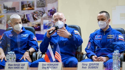 From left, U.S. astronaut Mark Vande Hei and Russian cosmonauts Oleg Novitsky and Pyotr Dubrov attend a news conference in the Baikonur Cosmodrome, Kazakhstan, April 8, 2021.