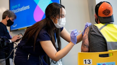 Registered nurse Sofia Mercado administers a vaccine at an Amazon Fulfillment Center, North Las Vegas, Nev., March 31, 2021.