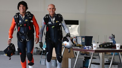 French pilot Vincent Reffet, left, and his mentor Yves Rossy prepare for a fly in Dubai, May 12, 2015.