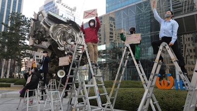 Activists stage a rally supporting Myanmar's democracy outside the POSCO office in Seoul, Feb. 22, 2021.
