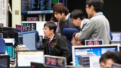 Staff of the Hayabusa2 Project watch monitors for a safety check at the control room of the JAXA Institute of Space and Astronautical Science in Sagamihara, Japan, Feb. 21, 2019.