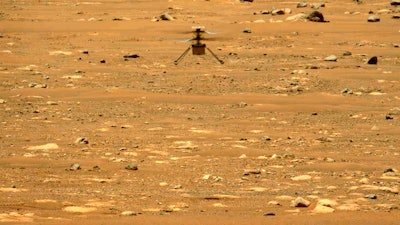The Mars Ingenuity helicopter hovers above the surface of the planet during its second flight, April 22, 2021.