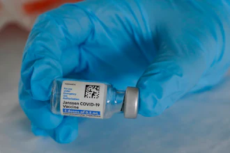 U.S. Army medic Kristen Rogers, of Waxhaw, N.C., holds a vial of the Johnson & Johnson COVID-19 vaccine in North Miami, Fla., March 3, 2021.