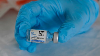 U.S. Army medic Kristen Rogers, of Waxhaw, N.C., holds a vial of the Johnson & Johnson COVID-19 vaccine in North Miami, Fla., March 3, 2021.