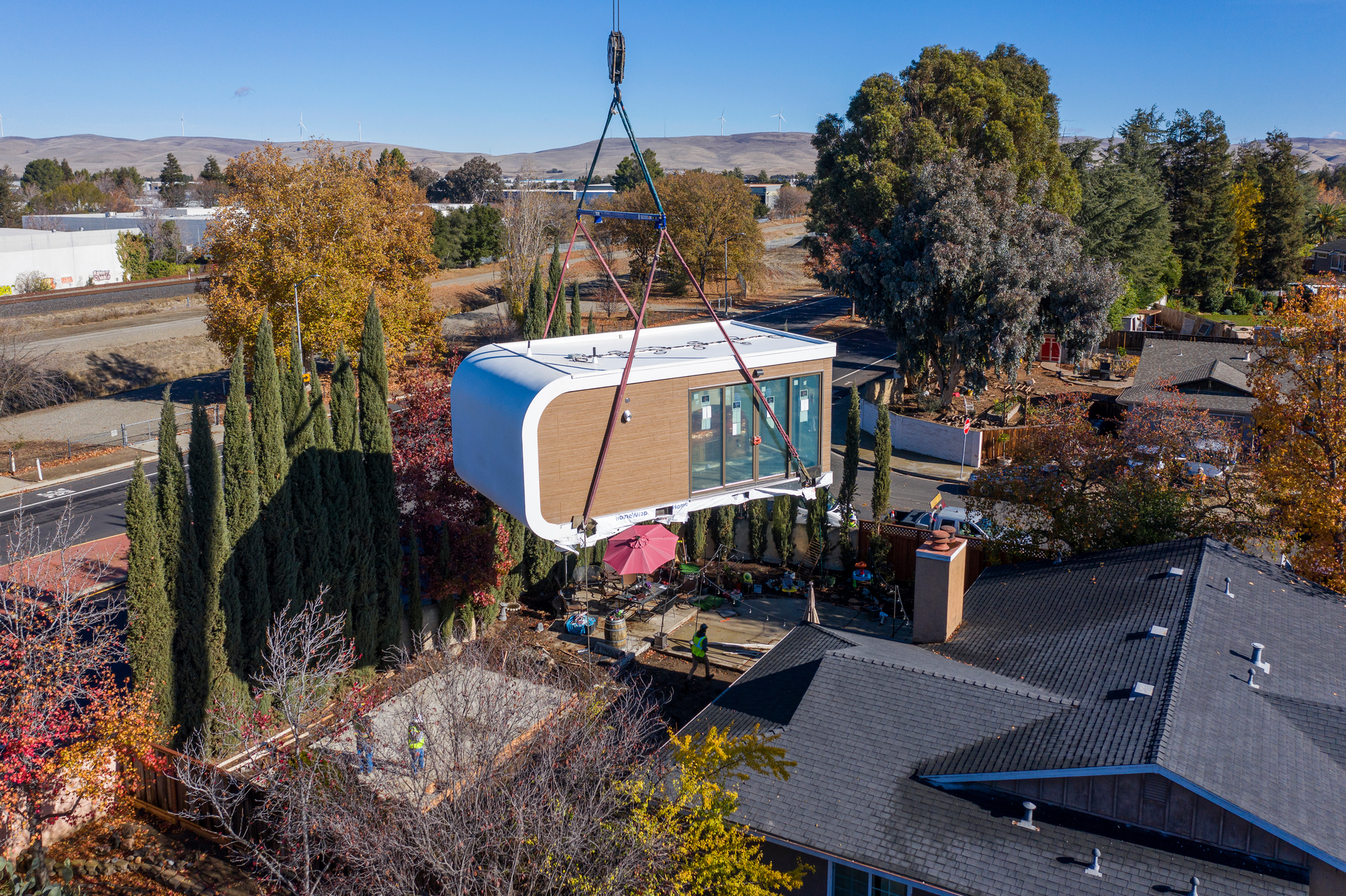 This photo provided by Mighty Buildings shows a 3D-printed housing module being delivered. Most of the modules built by Mighty Buildings are assembled in the factory, transported by truck to the owner&rsquo;s property, then put into place using a crane.