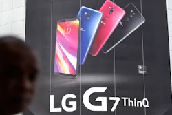 In this file photo, a visitor walks by an advertisement of LG Electronics' product at an electronic shop area in Seoul, South Korea.