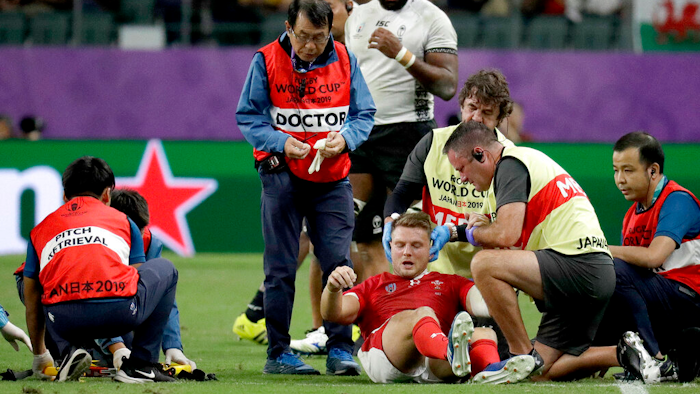 Wales' Dan Biggar is assisted after he was injured during the Rugby World Cup Pool D game at Oita Stadium between Wales and Fiji in Oita, Japan, Oct. 9, 2019.