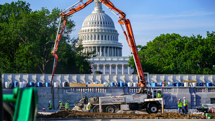A concrete pump frames the Capitol Dome during renovations and repairs to Lower Senate Park on Capitol Hill in Washington, May 18, 2021.
