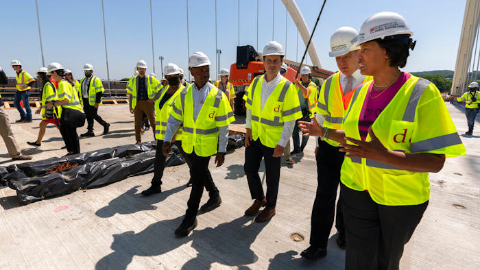 From right, District of Columbia Mayor Muriel Bowser, Secretary of Labor Marty Walsh, and Secretary of Transportation Pete Buttigieg at the Frederick Douglass Memorial Bridge in Washington, May 19, 2021.