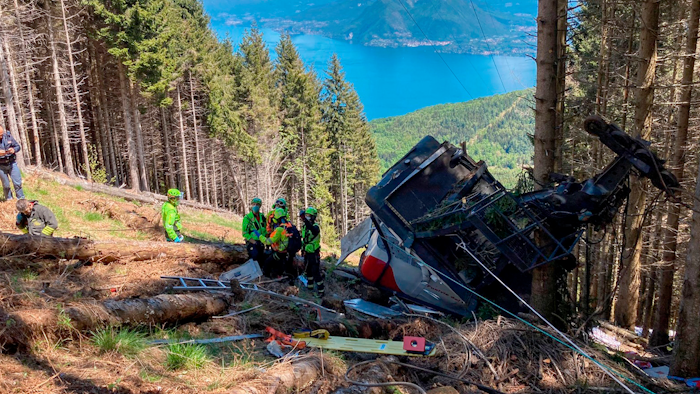 Rescuers work by the wreckage of a cable car after it collapsed near the summit of the Stresa-Mottarone line in the Piedmont region, northern Italy, May 23, 2021.