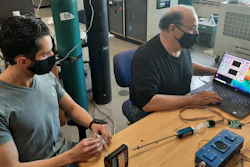 URI doctoral student Peter Ricci (left) and Professor Otto Gregory test the Digital Dog Nose sensors platform in Gregory's Thin Film Sensors Laboratory.