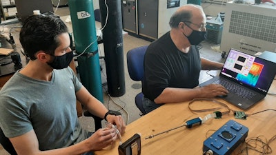 URI doctoral student Peter Ricci (left) and Professor Otto Gregory test the Digital Dog Nose sensors platform in Gregory's Thin Film Sensors Laboratory.