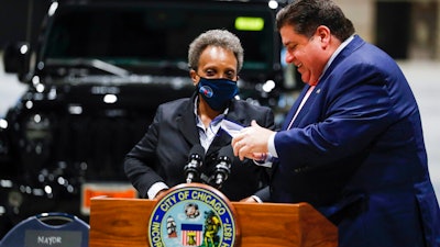 Governor J.B. Pritzker and Mayor Lori Lightfoot talk following a news conference, McCormick Place, Chicago, May 4, 2021.