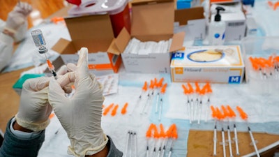 A Northwell Health registered nurses fills a syringe with the Johnson & Johnson COVID-19 vaccine, Albanian Islamic Cultural Center, Staten Island, New York, April 8, 2021.