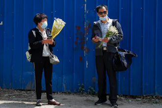 Wei Xiuwen, left, mother of Chen Mei, chats with Cai Jianli, father of Cai Wei, outside a courthouse in Beijing, May 11, 2021.