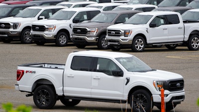 Ford pickup trucks built lacking computer chips are shown in parking lot storage in Dearborn, Mich., May 4, 2021.