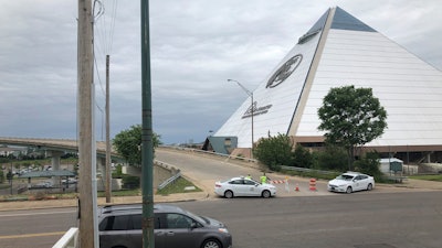 Transportation officers and police block an Interstate 40 onramp to the bridge over the Mississippi River near downtown Memphis, Tenn., on Tuesday, May 11, 2021. The Arkansas Department of Transportation tweeted on Tuesday that it found a crack during a routine inspection of the bridge.