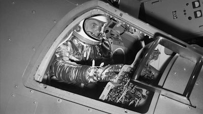 Marine Lt. Col. John Glenn reaches for controls inside a Mercury capsule procedures trainer, NASA Research Center, Langley Field, Va., Jan. 11, 1961.