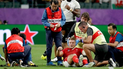 Wales' Dan Biggar is assisted after he was injured during the Rugby World Cup Pool D game at Oita Stadium between Wales and Fiji in Oita, Japan, Oct. 9, 2019.