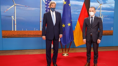 German Foreign Minister Heiko Maas, right, and U.S. Special Presidential Envoy for Climate John Kerry pose prior to a meeting at the Foreign Office in Berlin, May 18, 2021.