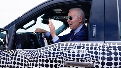 President Joe Biden stops to talk to the media as he drives a Ford F-150 Lightning truck, Ford Dearborn Development Center, Dearborn, Mich., May 18, 2021.