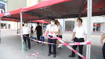 Government officials setup a cordon line at the SEG Plaza, Shenzhen, China, May 19, 2021.