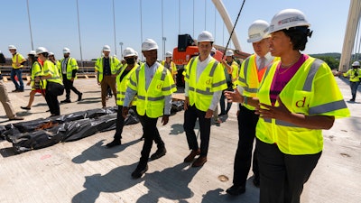 From right, District of Columbia Mayor Muriel Bowser, Secretary of Labor Marty Walsh, and Secretary of Transportation Pete Buttigieg at the Frederick Douglass Memorial Bridge in Washington, May 19, 2021.