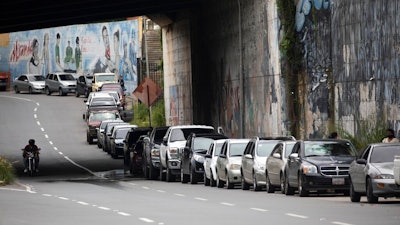 Vehicles line up near a gas station to fill their tanks in Caracas, Venezuela, Sept 8, 2020.