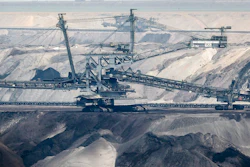 In this Thursday, April 29, 2021 file photo, giant bucket-wheel excavators extract coal at the controversial Garzweiler surface coal mine near Jackerath, west Germany. A report by the International Energy Agency on Tuesday, May 18, 2021 says immediate action is needed to reshape the world’s energy sector in order to meet ambitious climate goals by 2050. This includes ending investments in new coal mines, oil and gas wells.