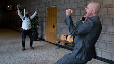 Milieudefensie director Donald Pols, right, celebrates the outcome of the verdict in the court case of Milieudefensie, the Dutch arm of the Friends of the Earth environmental organization, against Shell.