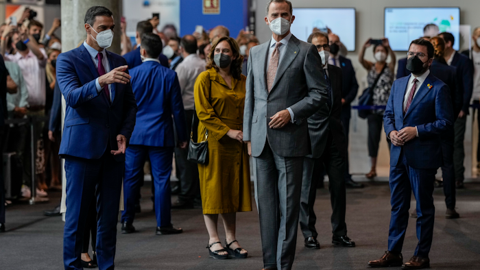Spanish prime minister Pedro Sanchez (left), Spain's King Felipe VI (center) and Catalan regional president Pere Aragones visit the Mobile World Congress 2021 venue in Barcelona, June, 28, 2021.