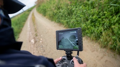 Police drone operator Thanassis Kyriakidis pilots a drone during a patrol at Evros river, near Feres, Greece, May 21, 2021.