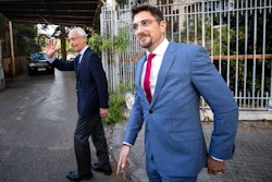 Members of Carlos Ghosn's defense team, Jean Yves Le Borgne, left, and Jean Tamalet leave the Justice Palace in Beirut, May 31, 2021.
