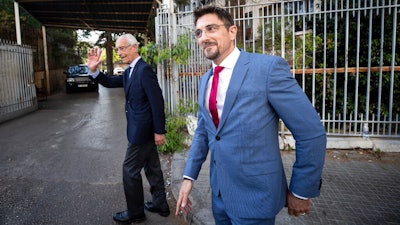 Members of Carlos Ghosn's defense team, Jean Yves Le Borgne, left, and Jean Tamalet leave the Justice Palace in Beirut, May 31, 2021.