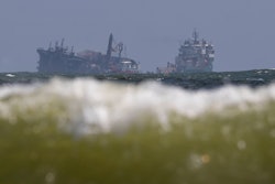 The MV X-Press Pearl, left, is pulled by a navel vessel at Kapungoda, where it is anchored off Colombo port, Sri Lanka, June 2, 2021.