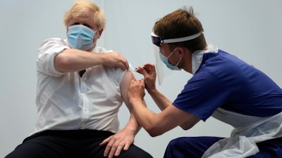 British Prime Minister Boris Johnson receives his second jab of the AstraZeneca coronavirus vaccine at the Francis Crick Institute in London, June 3, 2021.