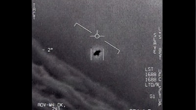 Image from a 2015 video, labelled Gimbal, shows an unexplained object tracked as it soars high along the clouds, traveling against the wind.