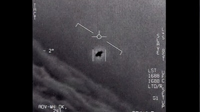 Image from a 2015 video, labelled Gimbal, shows an unexplained object tracked as it soars high along the clouds, traveling against the wind.