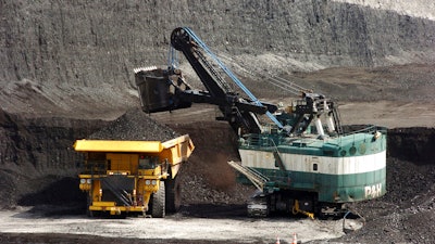A mechanized shovel loads a haul truck at the Spring Creek coal mine near Decker, Mont., April 4, 2013.