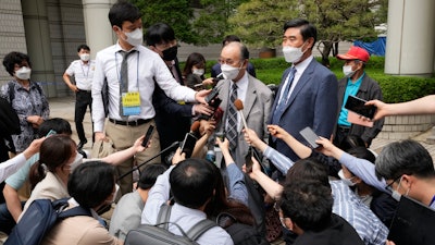 Lim Chul-ho, top center, the son of a deceased forced laborer, speaks at the Seoul Central District Court in Seoul, June 7, 2021.