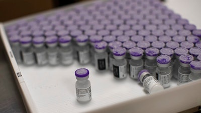 Frozen vials of the Pfizer/BioNTech COVID-19 vaccine are taken out to thaw, MontLegia CHC hospital, Liege, Belgium, Jan. 4, 2021.