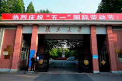 A security guard stands at the gate to the campus of Fudan University in Shanghai, April 28, 2017.