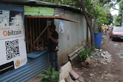 Santos Hilario Galvez makes a purchase at a store that accepts Bitcoin, Tamanique, El Salvador, June 9, 2021.