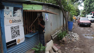 Santos Hilario Galvez makes a purchase at a store that accepts Bitcoin, Tamanique, El Salvador, June 9, 2021.