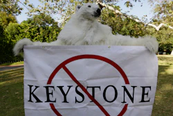 A member of the Center for Biological Diversity, in polar bear costume, protests the Keystone XL pipeline during a visit by then-President Barack Obama to Los Angeles, May 7, 2014.