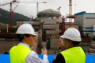 Then-British Chancellor of the Exchequer George Osborne, left, chats with Taishan Nuclear Power Joint Venture Co. Ltd. General Manager Guo Liming as he inspects a nuclear reactor under construction in Taishan, China, Oct. 17, 2013.