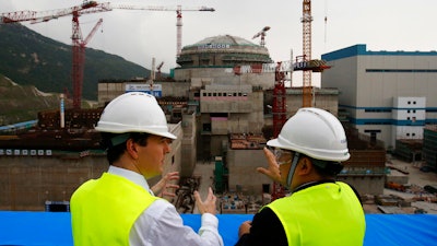 Then-British Chancellor of the Exchequer George Osborne, left, chats with Taishan Nuclear Power Joint Venture Co. Ltd. General Manager Guo Liming as he inspects a nuclear reactor under construction in Taishan, China, Oct. 17, 2013.