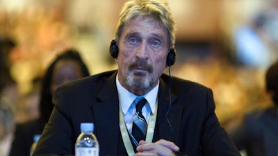John McAfee listens during the 4th China Internet Security Conference in Beijing, Aug. 16, 2016.