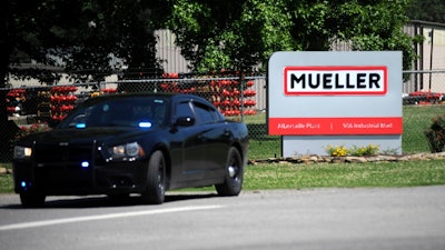 A police car guards the entrance to a Mueller Co. fire hydrant plant, Albertville, Ala., June 15, 2021.